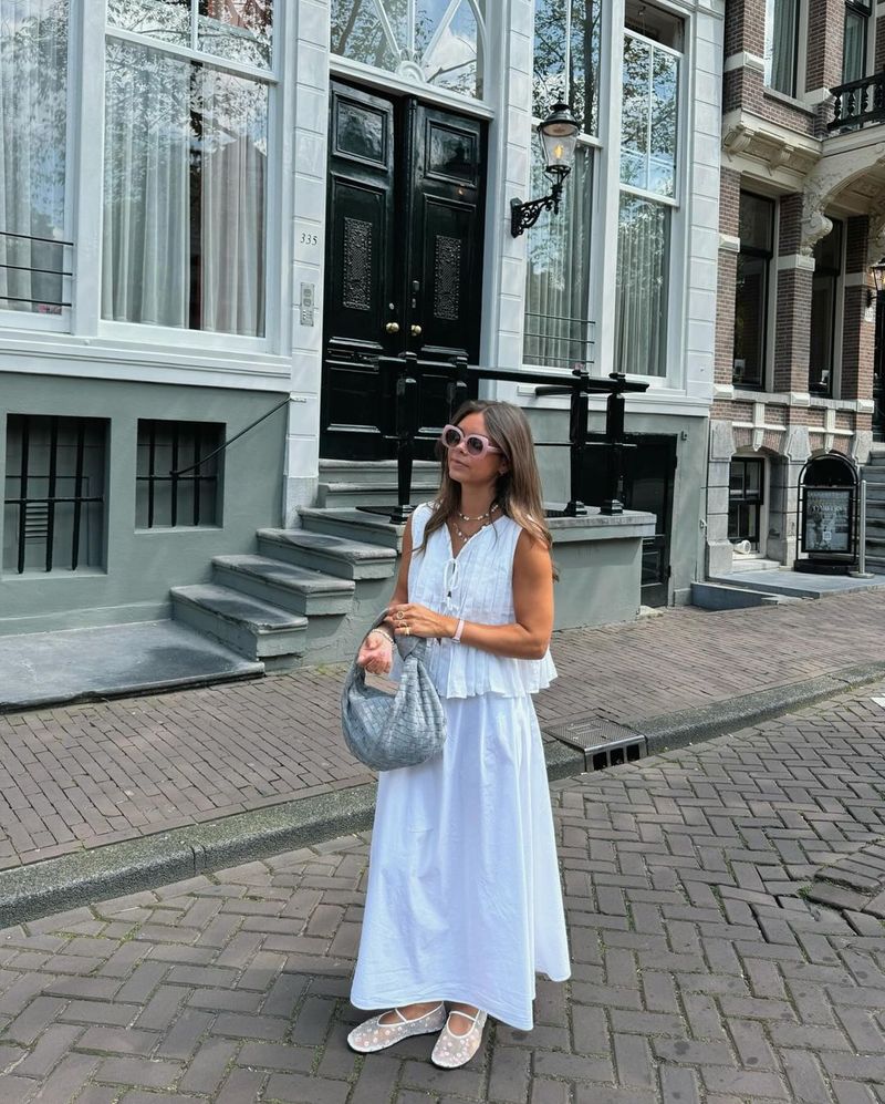 Completo da donna europeo e americano, primavera ed estate 2025, in cotone e lino, senza maniche, due pezzi, con camicia e gonna lunga da donna con spalline sottili._voghion.com