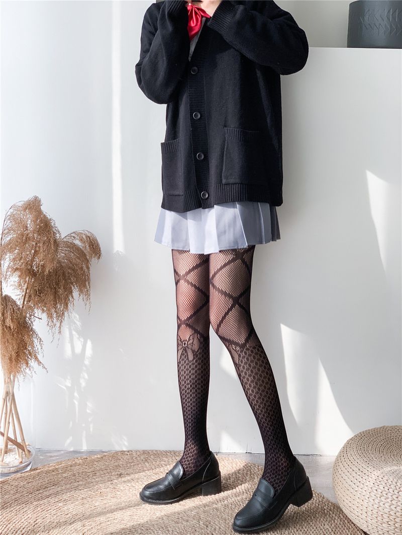 2024 Medias negras ahuecadas prensadas en caliente Jk Pantalones de malla sexy Letras grandes atractivas Calcetines de red de pesca con lazo_voghion.com