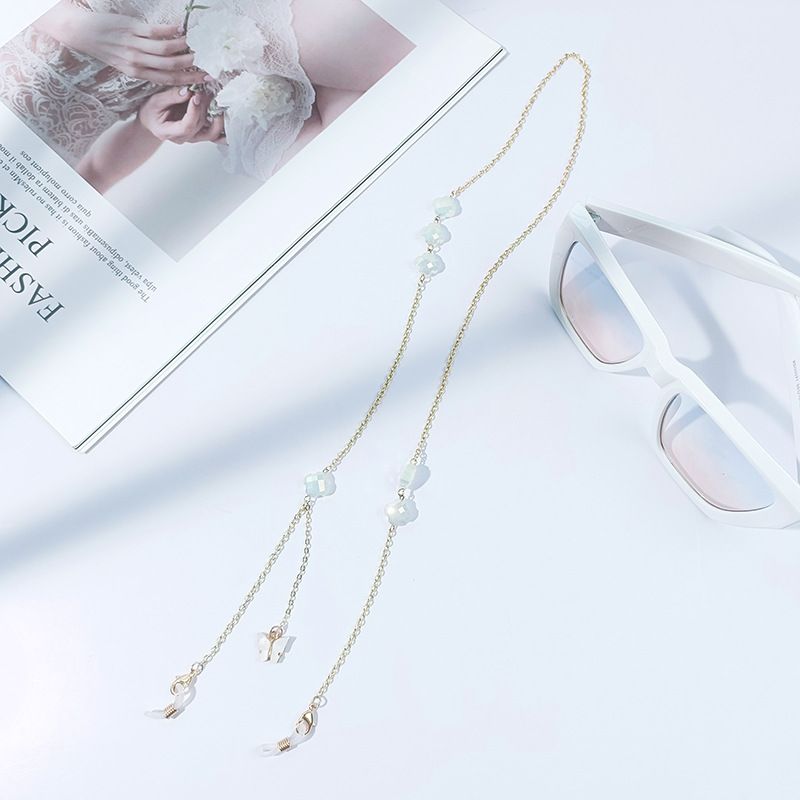 Cadena para gafas sencilla con máscara de retención de color dorado y trébol de cuatro hojas de alta gama._voghion.com