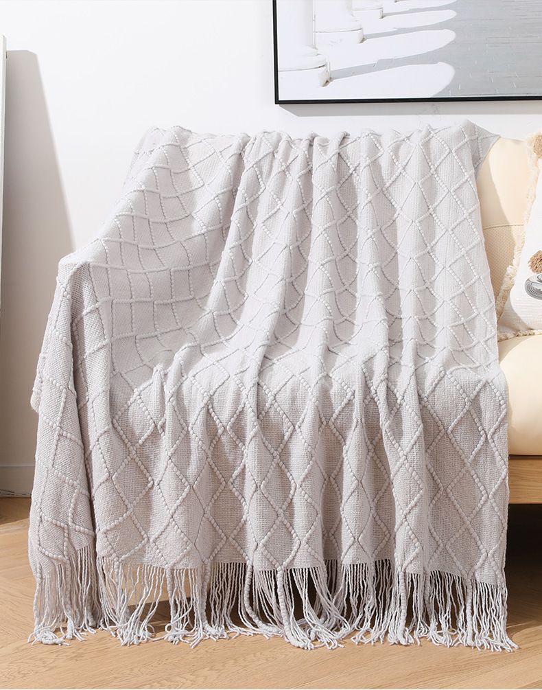 Divano nordico lavorato a maglia disegno geometrico nappa lana piccola coperta estiva in filo americano tessuto_voghion.com