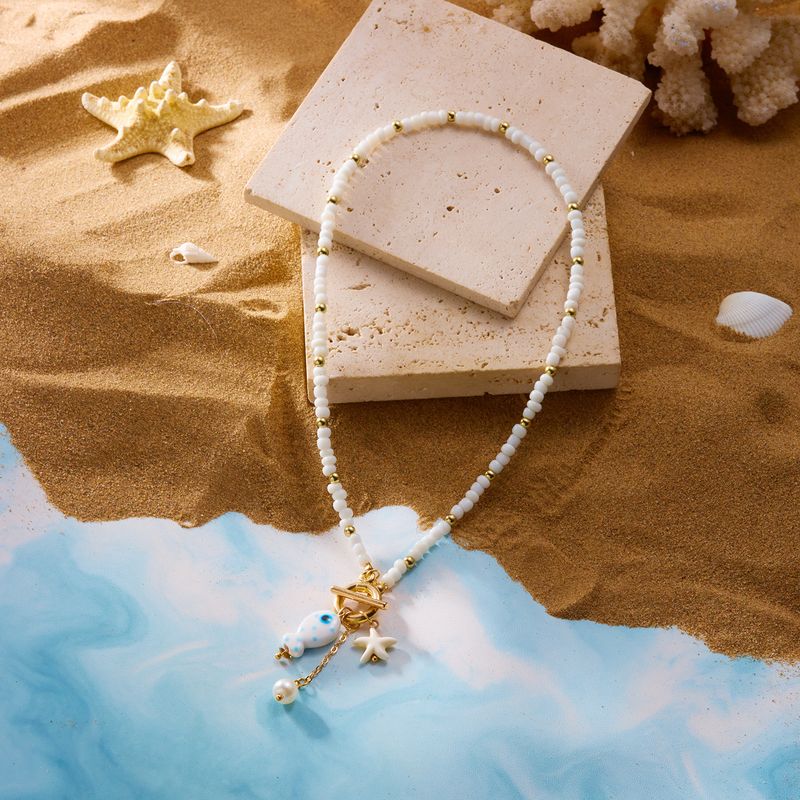 Nouveau collier double rang de perles de riz, pompon en céramique et fermoir OT, orné de petits poissons et d'étoiles de mer._voghion.com