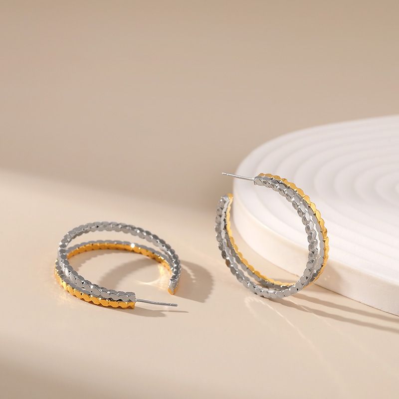 Gold and silver contrasting design personality earrings K real gold plated niche metal texture cross twist earrings_voghion.com