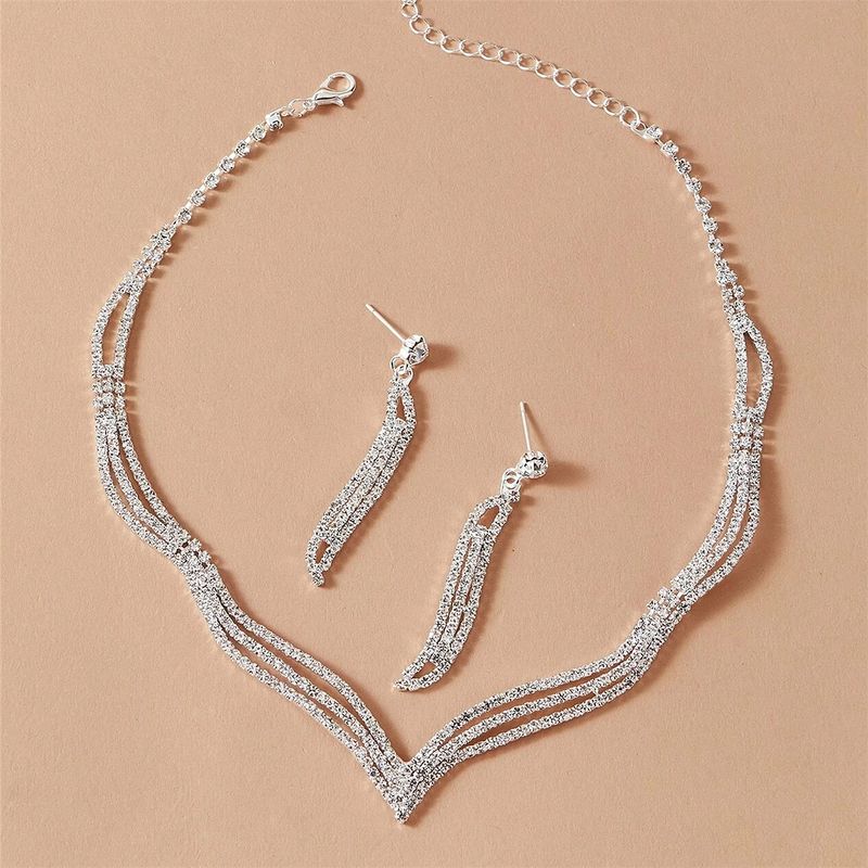 Set di gioielli da donna con collana di strass, orecchini, bracciale, anello e pochette per matrimoni, feste e serate, composto da cinque pezzi._voghion.com