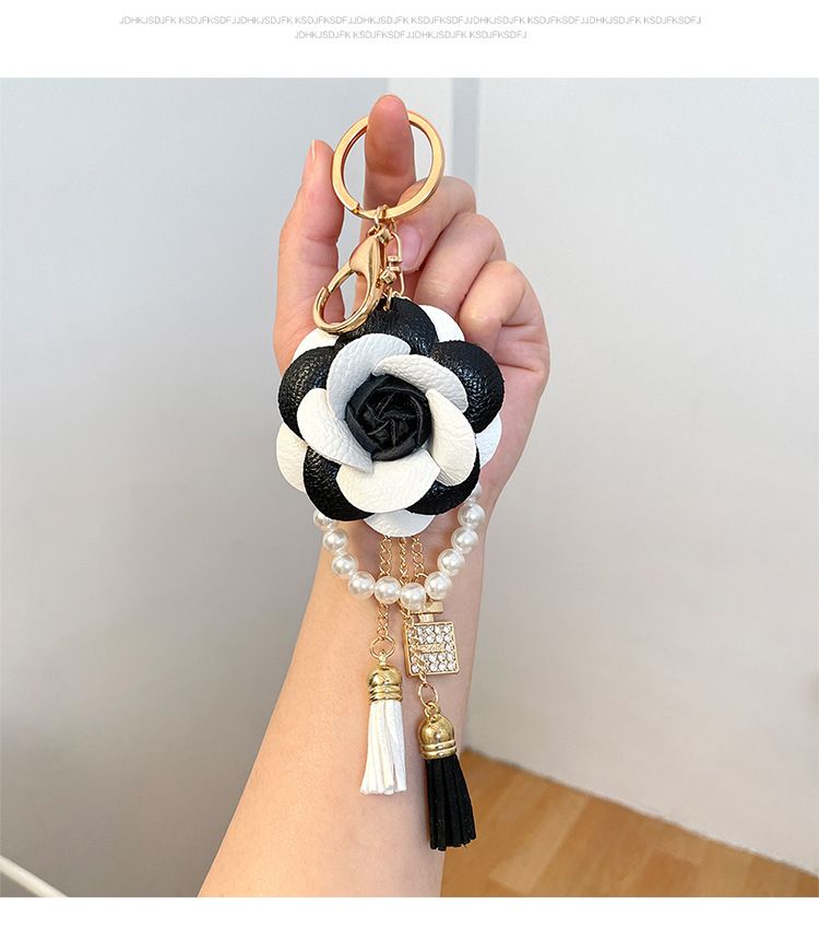 Portachiavi per auto con bottiglia di profumo in filo di perle di camelia bianca e nera, stile coreano, ciondolo per borsa da donna, piccolo_voghion.com