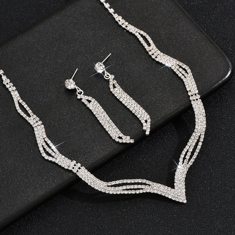 Set di gioielli da sposa con collana, orecchini, bracciale e anello, quattro pezzi, catena con griffe e strass_voghion.com