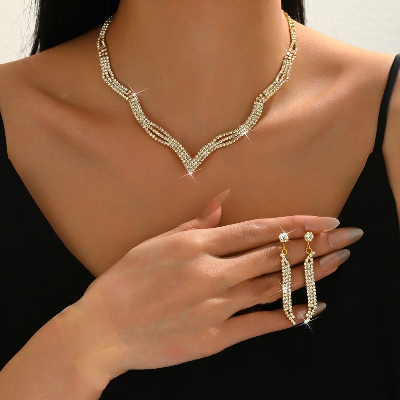 Set di gioielli da sposa con collana, orecchini, bracciale e anello, quattro pezzi, catena con griffe e strass_voghion.com