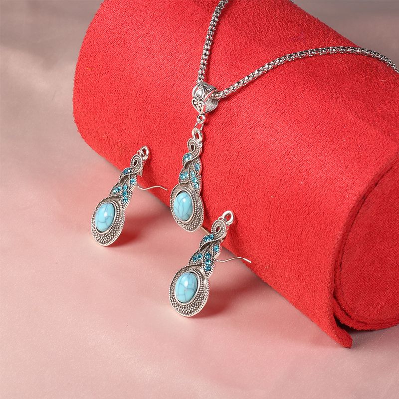 Collana e orecchini con motivo a ventaglio in cristallo blu e turchese_voghion.com