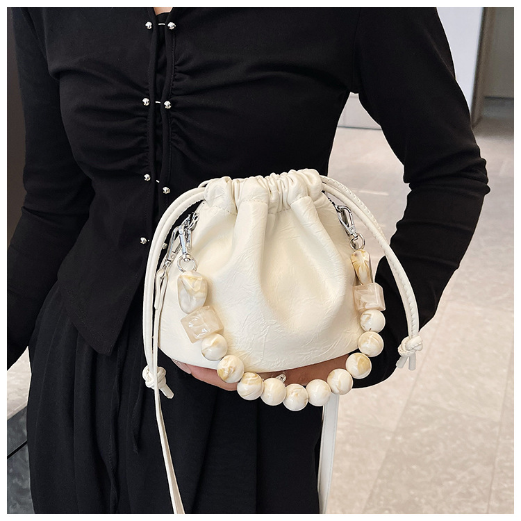 Autumn and winter minority foreign milk candy pearl drawstring fold Korean style advanced sense of light luxury 100 shoulder armpit oblique span bag_voghion.com
