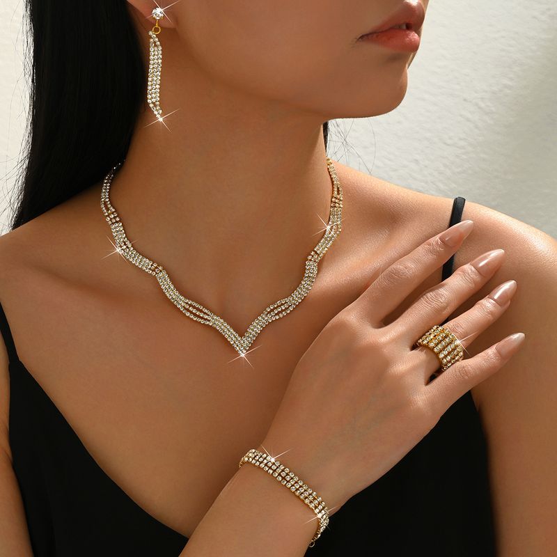 Set di gioielli da sposa con collana, orecchini, bracciale e anello, quattro pezzi, catena con griffe e strass_voghion.com