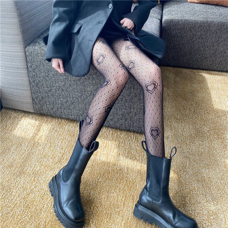 2024 Medias negras ahuecadas prensadas en caliente Jk Pantalones de malla sexy Letras grandes atractivas Calcetines de red de pesca con lazo_voghion.com