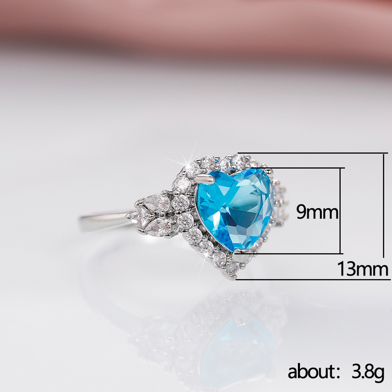 Conjunto de pendientes y anillo con colgante de corazón de océano con circonita azul topacio de nueva tendencia de Cao Shi Live para mujer_voghion.com