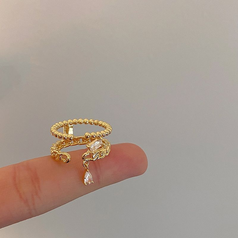 Goldfarbener, geflochtener Doppelring für Damen – Hohlzirkon-Detail, leichtes, luxuriöses Nischen-Zeigefinger-Design, verkupfert_voghion.com