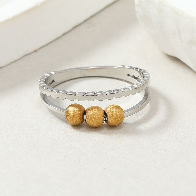 Anello in titanio alla moda con design di nicchia, anello a sfera mobile in acciaio a doppio strato cavo tagliato, accessorio di decompressione_voghion.com