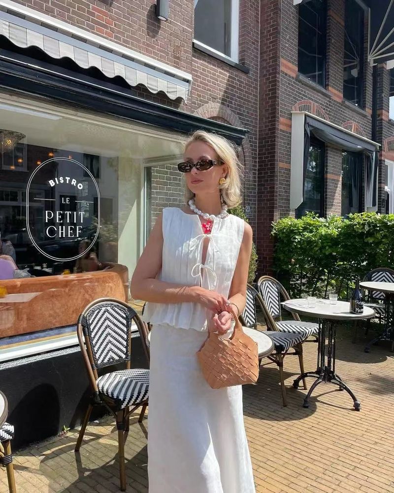 Completo da donna europeo e americano, primavera ed estate 2025, in cotone e lino, senza maniche, due pezzi, con camicia e gonna lunga da donna con spalline sottili._voghion.com