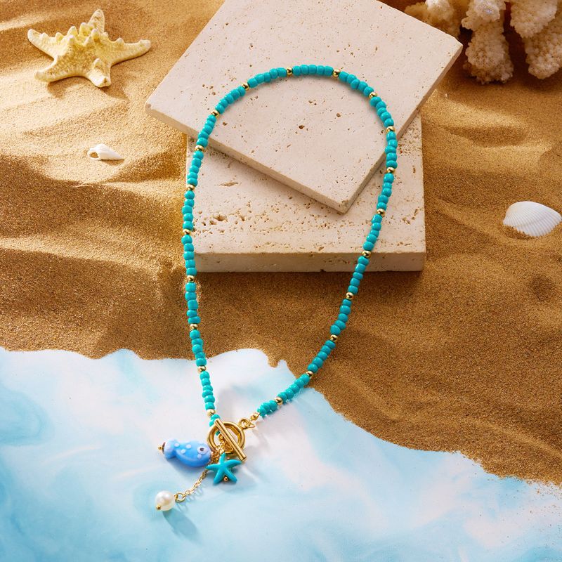 Nouveau collier double rang de perles de riz, pompon en céramique et fermoir OT, orné de petits poissons et d'étoiles de mer._voghion.com