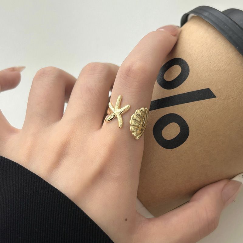 Anello aperto da donna con design a conchiglia di stella marina alla moda, adatto per viaggi in spiaggia_voghion.com