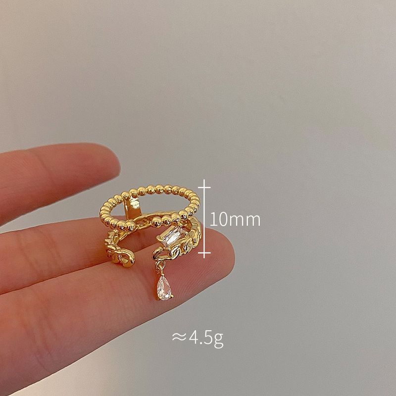 Goldfarbener, geflochtener Doppelring für Damen – Hohlzirkon-Detail, leichtes, luxuriöses Nischen-Zeigefinger-Design, verkupfert_voghion.com