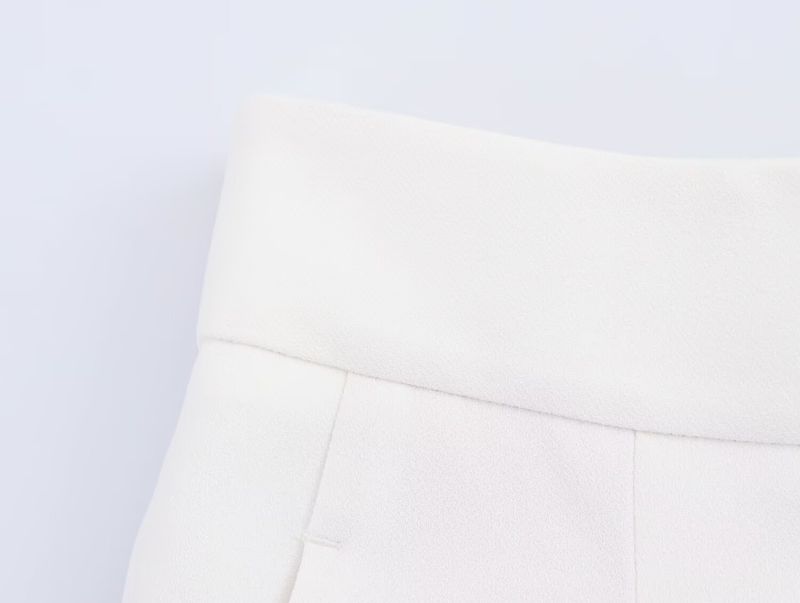 Traje de mujer de moda con chaleco asimétrico sencillo con cuello en V y pantalón ancho plisado._voghion.com