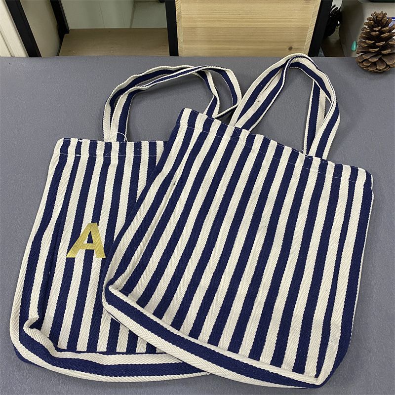 Bolsa de compras unissex de lona com listras verticais Lotte Korea AP_voghion.com
