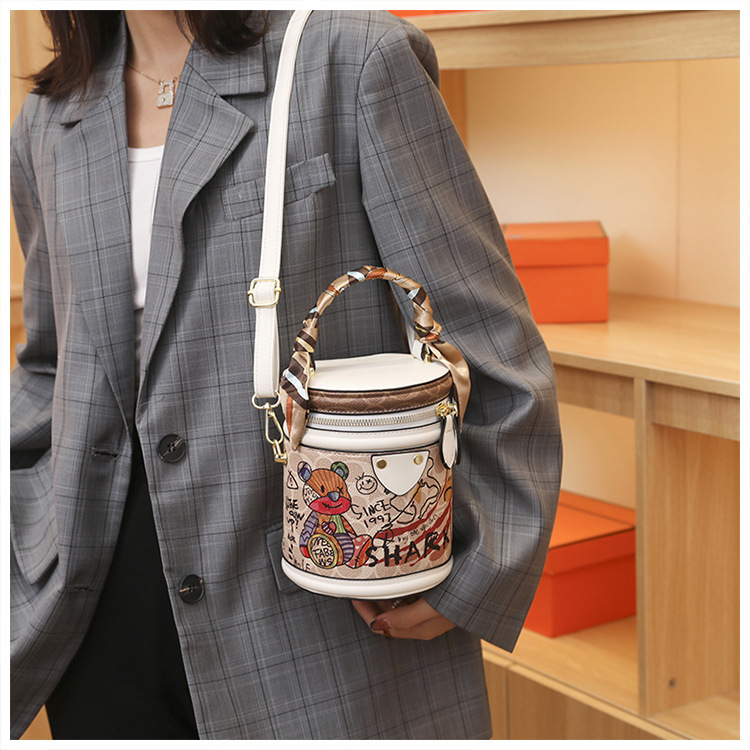 Graffiti bucket in 2024, new fashionable niche cylindrical bag, handheld one shoulder crossbody bag for women_voghion.com