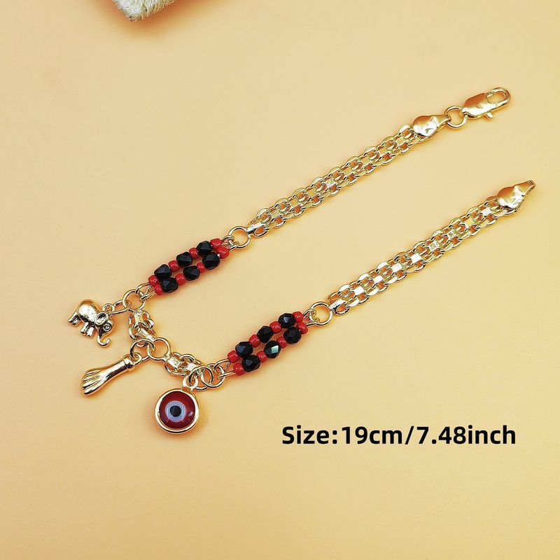 Braccialetto in stile bohémien con perline rosse e nere, con occhio malvagio, placcato in rame con oro 14 carati_voghion.com