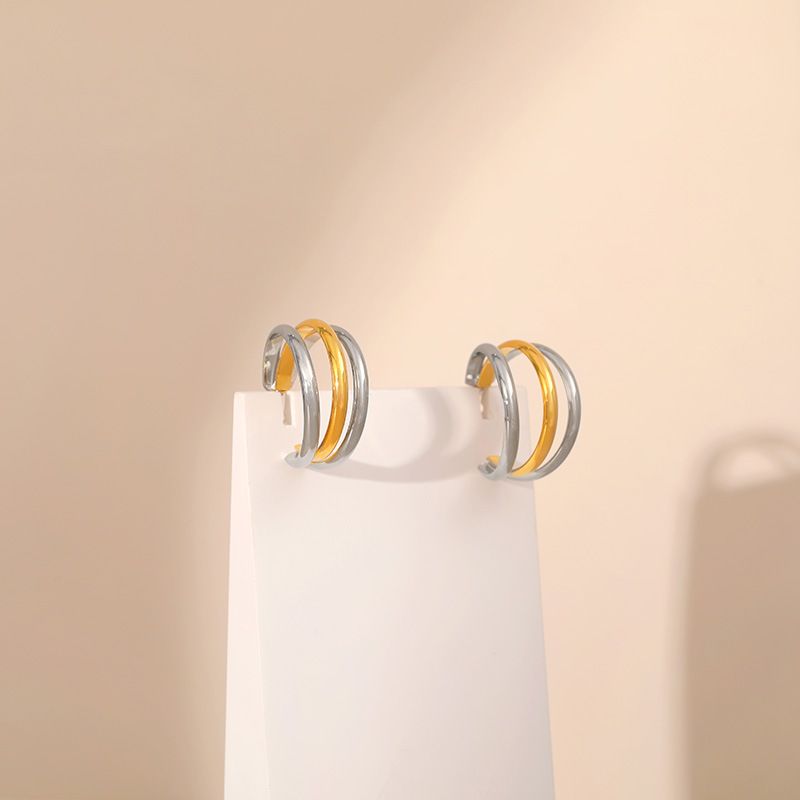 Gold and silver contrasting design personality earrings K real gold plated niche metal texture cross twist earrings_voghion.com