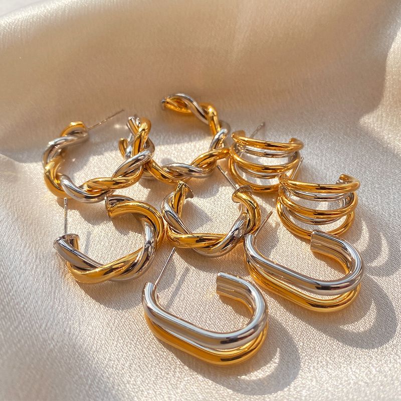 Gold and silver contrasting design personality earrings K real gold plated niche metal texture cross twist earrings_voghion.com