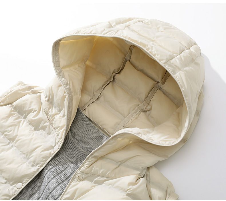 "Gilet leggero da donna slim fit in piuma d'oca, lunghezza media, con cappuccio, design laminato senza cuciture, color cachi/nero/beige"_voghion.com