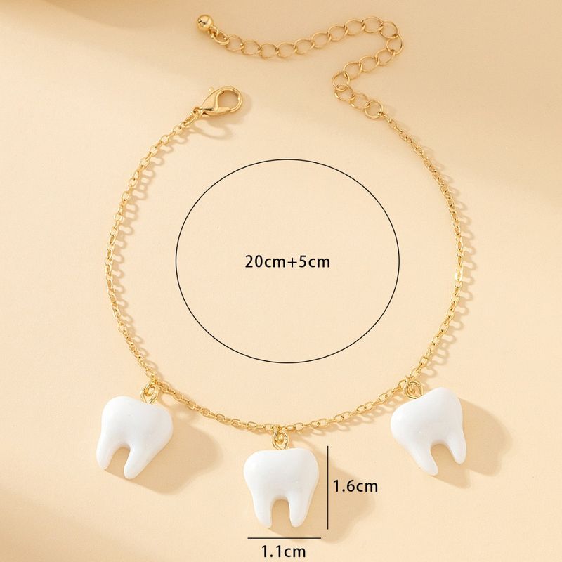 Un ciondolo alla caviglia unico, carino e realistico, alla moda, con piccoli denti, accessori per le vacanze al mare_voghion.com
