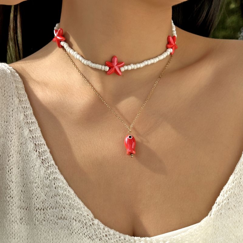 Nouveau collier double rang de perles de riz, pompon en céramique et fermoir OT, orné de petits poissons et d'étoiles de mer._voghion.com